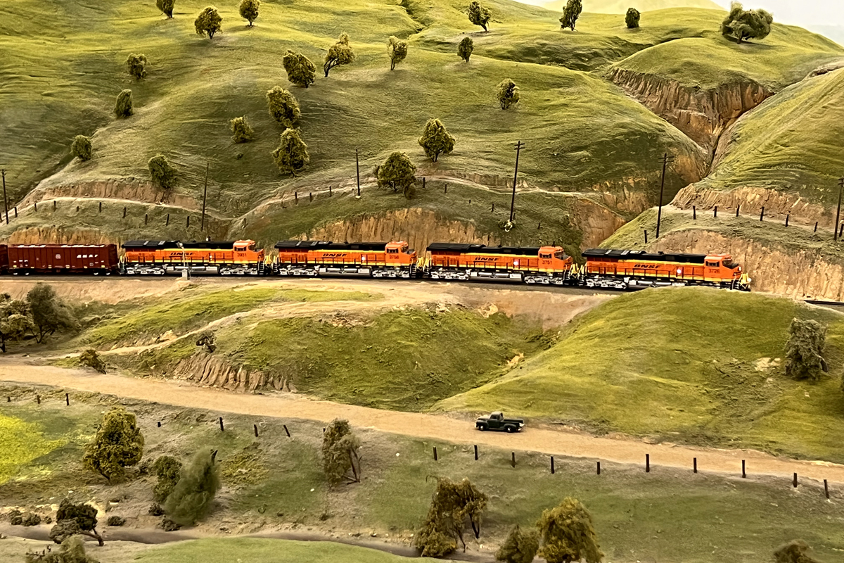 Pictured above is some scenery at the HO scale La Mesa Model Railroad Club. You can notice the rock formations, a road, trees, ground cover and more. 
