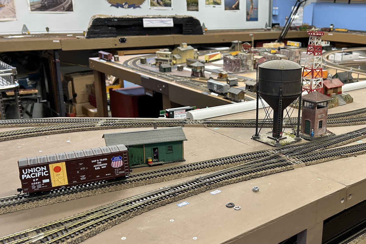 Union Pacific box car near a small building and the water tower. 